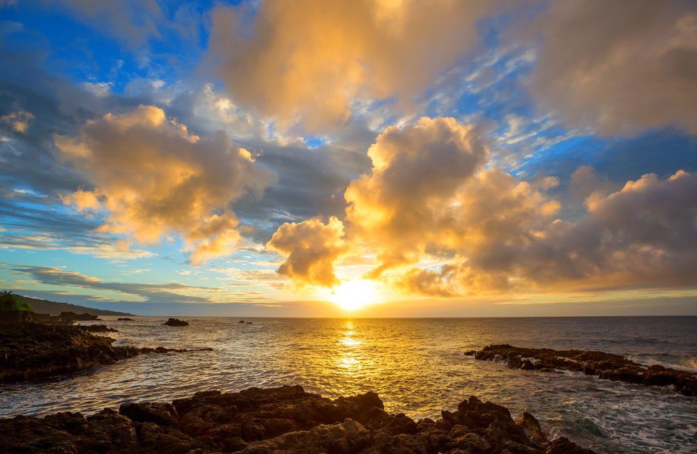 Hawaiian Sunset over rocky shore