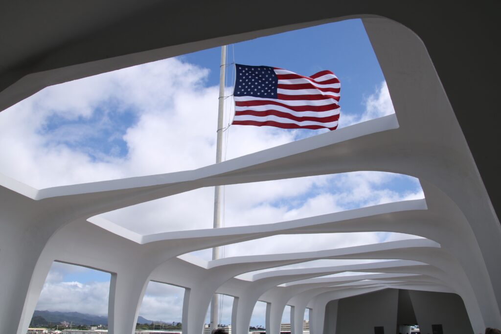 Flag waving above Arizona Memorial Pearl Harbor