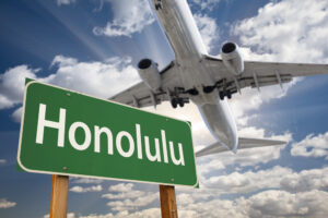 honolulu,green,road,sign,and,airplane,above,with,dramatic,blue