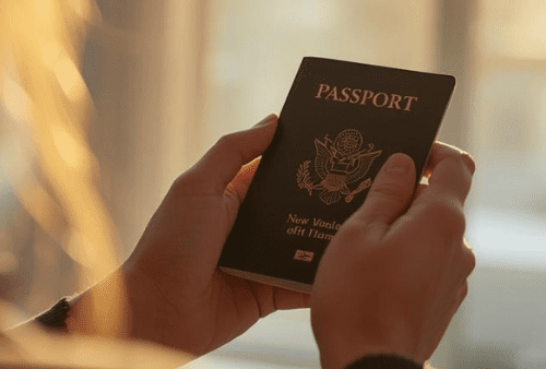 looking over woman's shoulder, she is holding a passport
