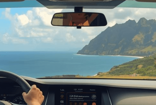 View from driving car of Hawaii mountain and ocean scenery.