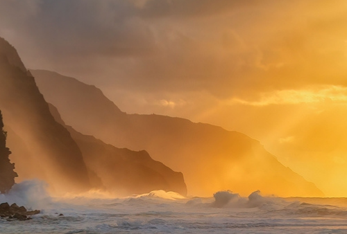 A beautiful shot of the silhouette of rocky cliffs on Kauai island during the sunset