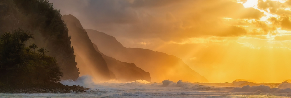 A beautiful shot of the silhouette of rocky cliffs on Kauai island during the sunset