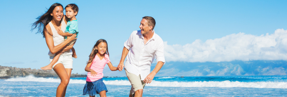 Family of four playing on beach