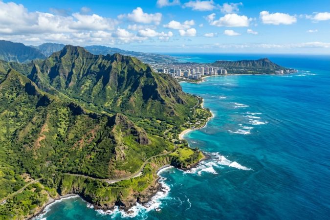 Coastline of Oahum green mountain cliffs, Waikiki and Diamond Head in background